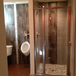 industrial style bath with toilet and urinal, metallica 12x24 with naxos brushed aluminum tile, pebble shower floor, metal epoxy concrete floor