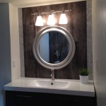 basement bath vanity...ikea cabinet, faucet and sink, metallica 12x24 tile wall with naxos brushed aluminum stripes on each end